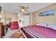 Bedroom featuring a comfortable bed, full-length mirror, and ceiling fan at 22029 E Irish Dr, Aurora, CO 80016