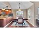 Dining area with hardwood floors, a large window, and a stylish chandelier at 22029 E Irish Dr, Aurora, CO 80016