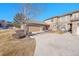 Exterior view of a townhome featuring a two-car garage and a purple front door at 22029 E Irish Dr, Aurora, CO 80016