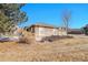 Side exterior of a well-maintained home with stone accents and landscaping at 22029 E Irish Dr, Aurora, CO 80016