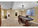 Finished basement game room with a poker table and chandelier lighting at 22029 E Irish Dr, Aurora, CO 80016