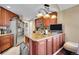 Well-equipped kitchen featuring stainless steel appliances, a kitchen island, and ample cabinet space at 22029 E Irish Dr, Aurora, CO 80016