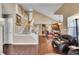 Open-concept living room with staircase, wood floors, and view into the kitchen at 22029 E Irish Dr, Aurora, CO 80016