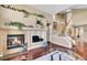 Inviting living room with a fireplace, staircase, and rich wood floors at 22029 E Irish Dr, Aurora, CO 80016