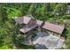 Elevated view of house with large driveway and a covered porch surrounded by lush greenery at 5519 Ponderosa Dr, Parker, CO 80134