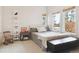 Bright bedroom with decor shelving, neutral tones, and a view to the outside at 5519 Ponderosa Dr, Parker, CO 80134