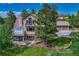 Two-story home featuring a solarium, back porch, and an attached two car garage at 5519 Ponderosa Dr, Parker, CO 80134
