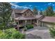 Beautiful home featuring stone accents, large covered porch, and attached two car garage at 5519 Ponderosa Dr, Parker, CO 80134
