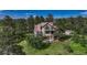 Two-story home featuring a balcony, deck, and lush landscaping at 5519 Ponderosa Dr, Parker, CO 80134