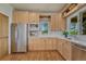 Cozy kitchen featuring natural light, stainless steel appliances, and ample wood cabinets at 5519 Ponderosa Dr, Parker, CO 80134