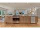 Bright, open kitchen featuring a large island with stainless steel appliances and hardwood floors at 5519 Ponderosa Dr, Parker, CO 80134