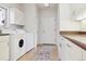 Spacious laundry room with washer, dryer, utility sink and plenty of cabinets for storage at 5519 Ponderosa Dr, Parker, CO 80134