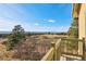 Expansive mountain views from the outdoor deck with wood railing and landscaping at 5519 Ponderosa Dr, Parker, CO 80134