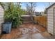 Private backyard features brick patio for outdoor enjoyment, with a mix of greenery and trees at 9624 W Chatfield Ave # D, Littleton, CO 80128