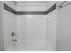 A well-maintained bathtub and shower, showcasing contemporary tile work and fixtures at 9624 W Chatfield Ave # D, Littleton, CO 80128