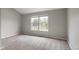 Spacious bedroom with two large windows providing ample natural light and plush carpeting at 9624 W Chatfield Ave # D, Littleton, CO 80128