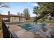 Inviting community pool with wooden pergola, offers a refreshing and relaxing escape for residents at 9624 W Chatfield Ave # D, Littleton, CO 80128