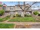 Charming townhome featuring a landscaped front yard and inviting entrance stairs at 9624 W Chatfield Ave # D, Littleton, CO 80128