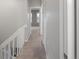 Upper level hallway featuring neutral walls, plush carpeting, and access to multiple rooms at 9624 W Chatfield Ave # D, Littleton, CO 80128