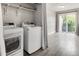 Well-equipped laundry area featuring modern washer and dryer units and ample natural light at 9624 W Chatfield Ave # D, Littleton, CO 80128