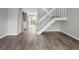 Open living room with a staircase and access to the laundry area, convenient and well-lit at 9624 W Chatfield Ave # D, Littleton, CO 80128