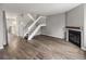 Bright living room featuring a cozy fireplace and a staircase, perfect for Gathering gatherings at 9624 W Chatfield Ave # D, Littleton, CO 80128