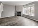 Comfortable living space with a fireplace and natural light streaming through the large window at 9624 W Chatfield Ave # D, Littleton, CO 80128