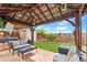 Backyard featuring a covered seating area with sofas and an outdoor backyard shed at 8240 Clayton Ct, Denver, CO 80229