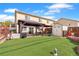 Spacious backyard featuring a covered patio, artificial turf, wooden fence, and storage shed at 8240 Clayton Ct, Denver, CO 80229