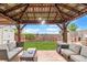 Outdoor patio features a wooden pergola with decorative lights, a stone tile floor and outdoor seating at 8240 Clayton Ct, Denver, CO 80229