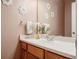 Well lit half-bathroom with a modern vanity, and decorative mirror at 8240 Clayton Ct, Denver, CO 80229
