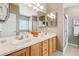 Bright bathroom featuring a dual sink vanity, ample counter space, and a shower at 8240 Clayton Ct, Denver, CO 80229