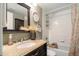 Bathroom featuring a decorative vanity, granite countertop, and shower over a soaking tub at 8240 Clayton Ct, Denver, CO 80229