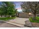 Charming single-Gathering home with a well-manicured front yard, mature trees and a two-car garage at 8240 Clayton Ct, Denver, CO 80229