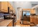 Efficient kitchen layout featuring stainless steel appliances, wood cabinetry, and a functional design at 8240 Clayton Ct, Denver, CO 80229