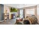 Inviting living room with a fireplace, large TV, and sliding door access to the outdoors at 8240 Clayton Ct, Denver, CO 80229