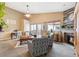 Cozy living room with vaulted ceilings, stylish furniture, wood burning fireplace, and access to the backyard at 8240 Clayton Ct, Denver, CO 80229