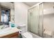 Small bathroom with shower-tub combo, frosted sliding doors, and single sink vanity at 2201 Sable Blvd # 1003, Aurora, CO 80011