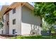 Side view of building exterior with siding, windows, and lawn at 2201 Sable Blvd # 1003, Aurora, CO 80011