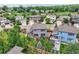 Aerial view of the fenced backyard featuring a stone patio with outdoor furniture and lush landscaping at 2150 Wagon Way, Louisville, CO 80027