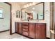 Bathroom featuring a double vanity with dark wood cabinets and a decorative flower arrangement at 2150 Wagon Way, Louisville, CO 80027
