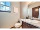 Elegant half bath with granite countertop, wood cabinets, and stylish decor at 2150 Wagon Way, Louisville, CO 80027