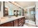 Spacious bathroom featuring a double vanity with stylish fixtures and a glass-enclosed shower at 2150 Wagon Way, Louisville, CO 80027