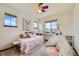Playful bedroom design featuring a pink bed, colorful ceiling fan, and creative decor at 2150 Wagon Way, Louisville, CO 80027
