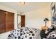 Comfortable bedroom with neutral walls, a decorative lamp and a cow-print comforter set at 2150 Wagon Way, Louisville, CO 80027