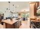 Open-concept kitchen with island seating, pendant lighting, and an adjacent dining area at 2150 Wagon Way, Louisville, CO 80027