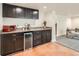Basement kitchenette featuring custom cabinets, a built in fridge, and stone countertops at 2150 Wagon Way, Louisville, CO 80027
