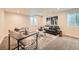 Cozy living room with modern furniture, carpeted floors and natural lighting through window wells at 2150 Wagon Way, Louisville, CO 80027