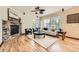 Bright living room featuring a stone fireplace, hardwood floors, and large windows at 2150 Wagon Way, Louisville, CO 80027