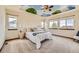 Light-filled bedroom with whimsical cloud mural ceiling, multiple windows, and neutral tones at 2150 Wagon Way, Louisville, CO 80027